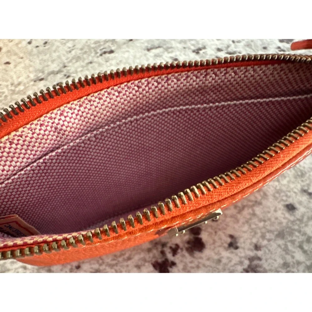 Dooney & Bourke pebble grain large slim wristlet bag in orange